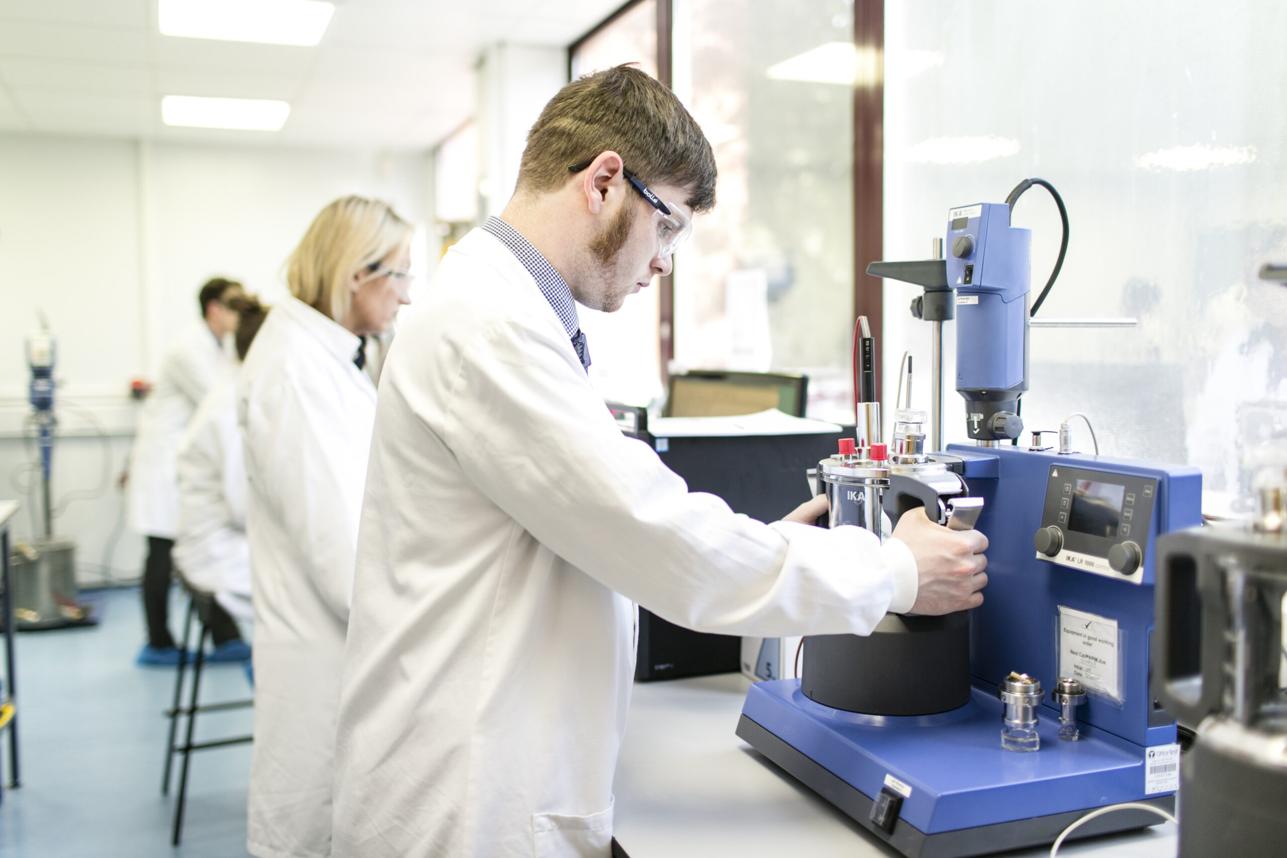 Scientist performing topical and transdermal formulation development testing in pharmaceutical laboratory